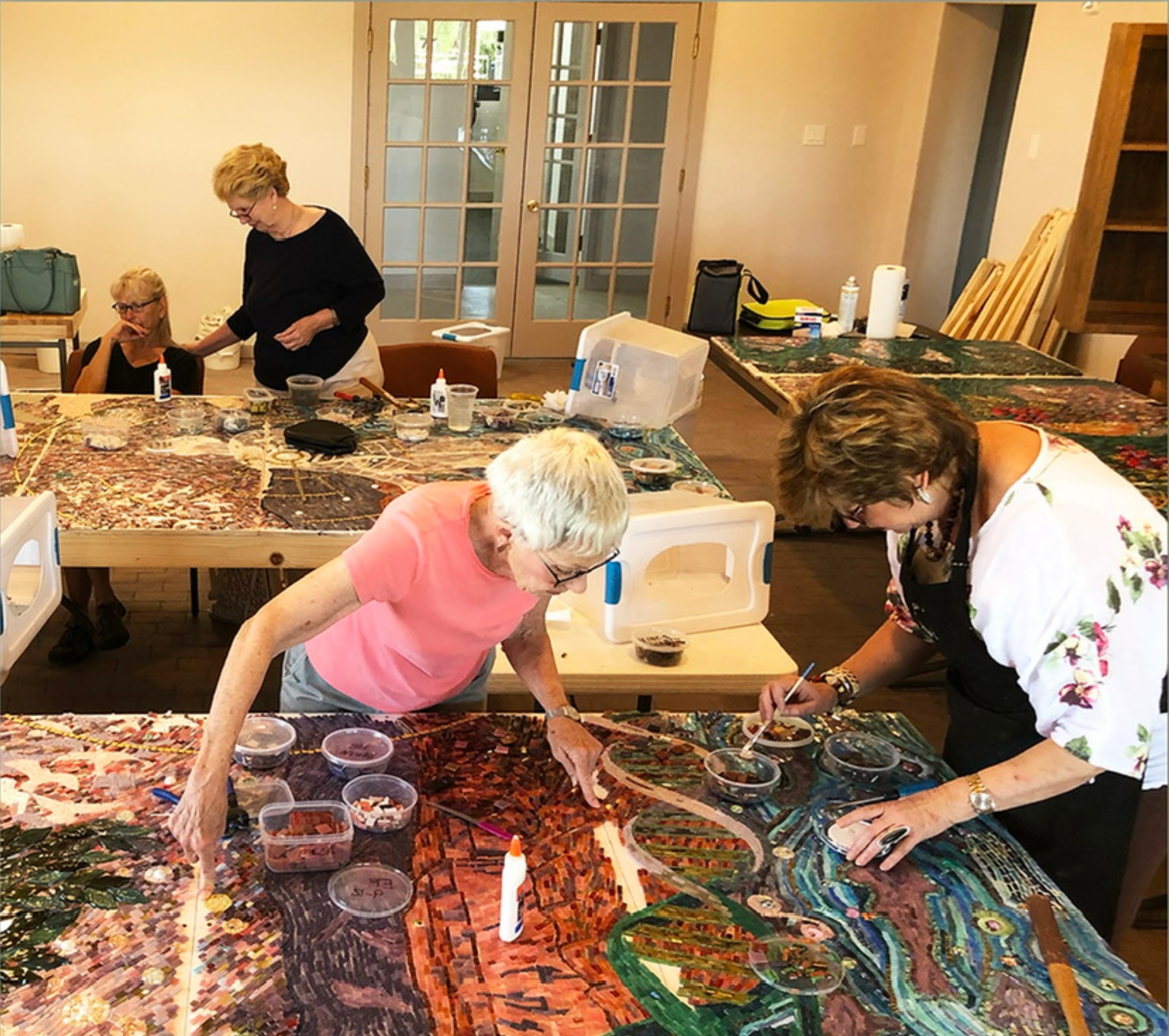 Workshop participants working on mosaic panels